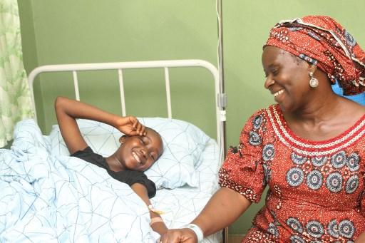 One of the 28 students of Bethel Baptist High School who have been released by their kidnappers is seen with her mother at Wilbasun Hospital and Maternity in Kaduna on July 26. Photo: AFP