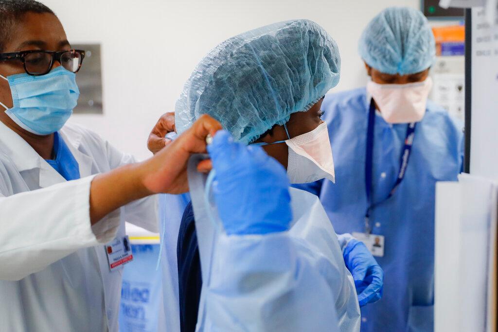 Medical personnel adjust their personal protective equipment while working in the emergency department at NYC Health + Hospitals Metropolitan in New York in this May 27, 2020 file photo. Photo: AP