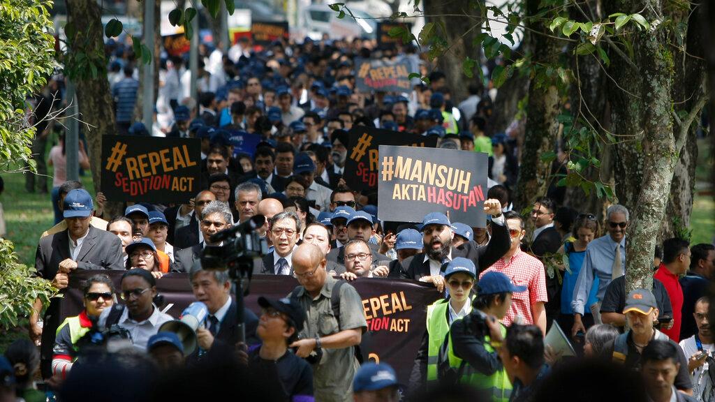 Protesters hold placards denouncing the Sedition Act 1948 during a demonstration at the Parliament building in Kuala Lumpur in this Oct 16, 2014 file photo. The notorious law is one of several which Putrajaya has said it intends to review and amend as part of its economic plan for the next five years. Photo: AP