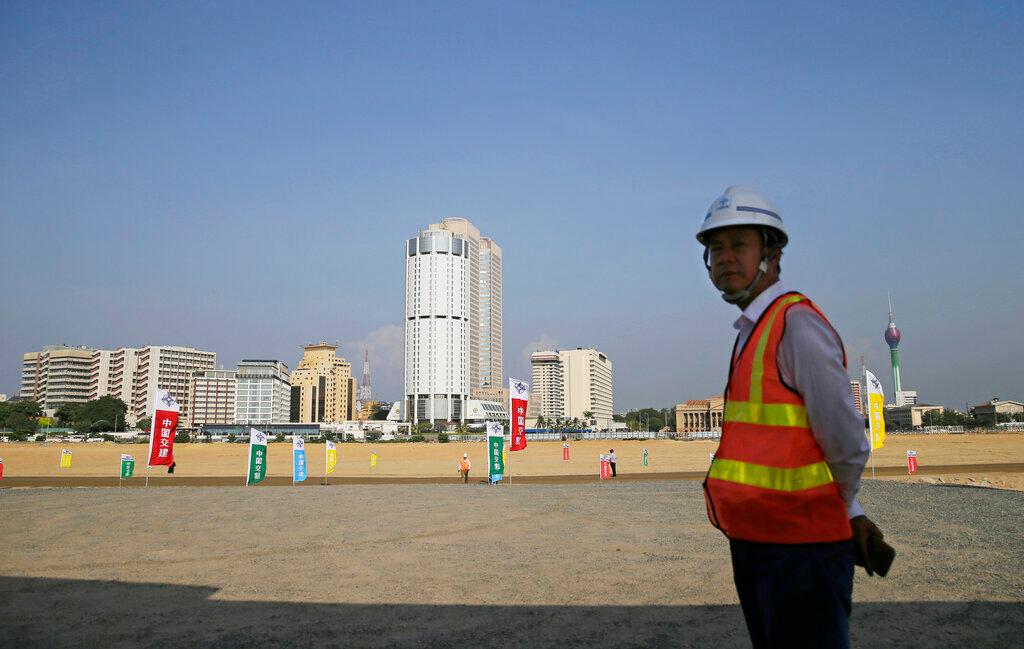 A Chinese construction worker stands on land reclaimed from the Indian Ocean for the Colombo Port City project, initiated as part of China's ambitious One Belt One Road initiative, in Colombo, Sri Lanka, in this Jan 2, 2018 file photo. Photo: AP