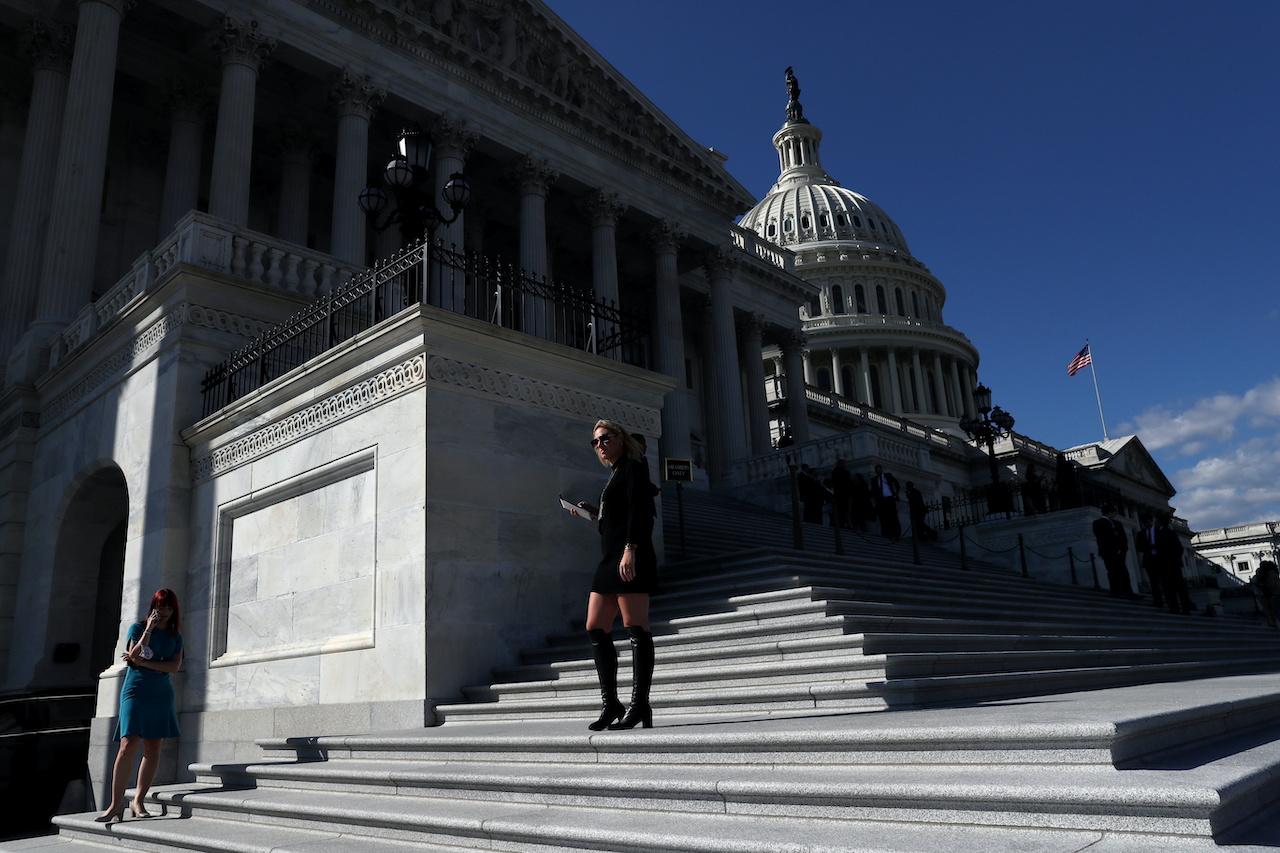 Reporters wait for members of congress to enter the building for a vote on Capitol Hill in Washington, US, Sept 30. Photo: Reuters
