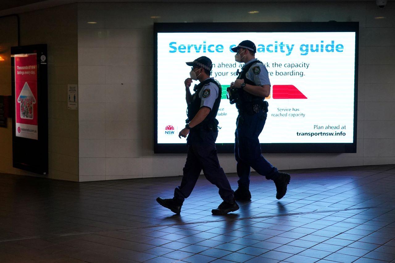 Police officers in protective face masks patrol a public transit station in the city centre during a lockdown to curb the spread of Covid-19 in Sydney, Australia, Sept 30. Photo: Reuters