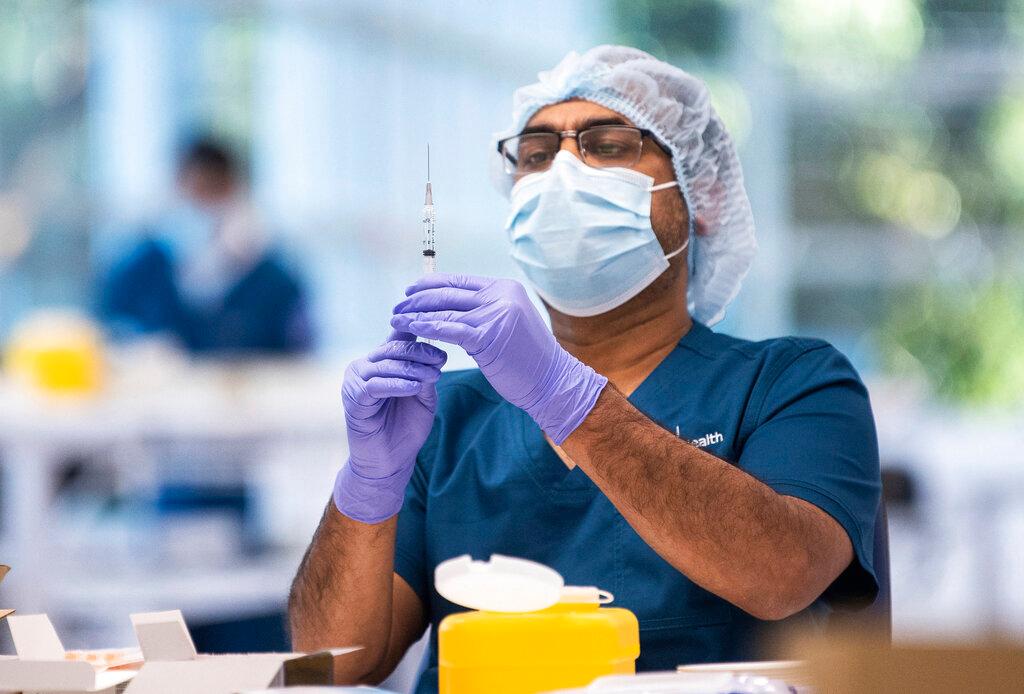 A technician prepares a Pfizer vaccine in the pharmacy area of the newly opened Covid-19 Vaccination Centre in Sydney, Australia, in this file photo dated May 10. Photo: AP
