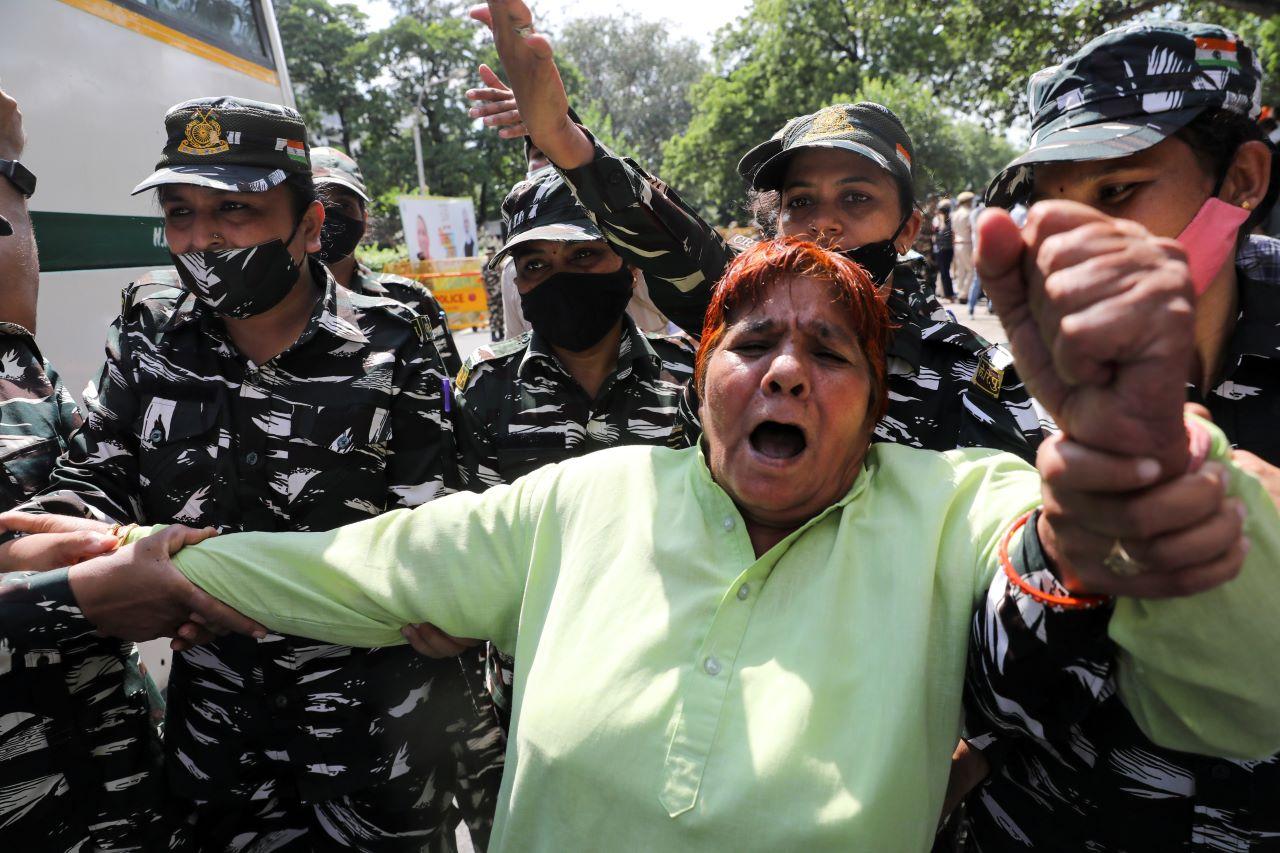 Police forces detain a person during a protest by activists of the youth wing of India's main opposition Congress party outside UP Bhawan, after people were killed when violence broke out in Uttar Pradesh state on Sunday, when a car linked to a federal minister ran over farmers taking part in a protest against controversial farm laws, in New Delhi, India, Oct 4. Photo: Reuters