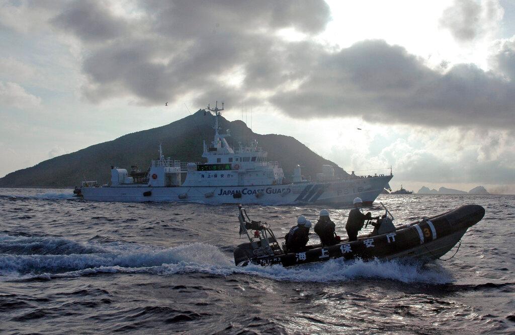In this Sunday, Aug 18, 2013, file photo, a Japanese Coast Guard boat and vessel sail alongside Japanese activists' fishing boat, not in photo, warning the activists away from a group of disputed islands called Senkaku by Japan and Diaoyu by China. In phone talks on Tuesday morning that lasted roughly 20 minutes, the allies also confirmed their cooperation toward achieving a free and open Indo-Pacific. Photo: AP