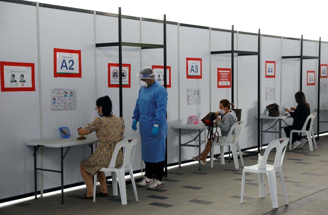People take antigen rapid tests under supervision, at a quick test centre in Singapore, Sept 28. Photo: Reuters