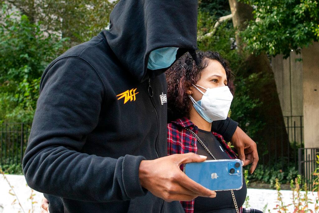 Former NBA basketball player Sebastian Telfair (left) records journalists on his phone as he departs Manhattan Federal Court, Oct 7, in New York. Telfair is one of 18 former players charged with allegedly defrauding the league's health insurance scheme of almost US$4 million. Photo: AP