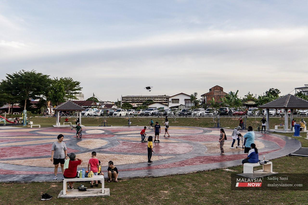 Families get some fresh air and exercise while children play at Taman Rekreasi Sungai Chua in Kajang, under Phase Three of the National Recovery Plan.