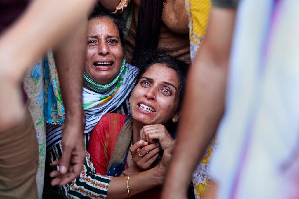 The wife of a schoolteacher who was killed in Kashmir mourns before the cremation in Jammu, India, Oct 8. Photo: AP