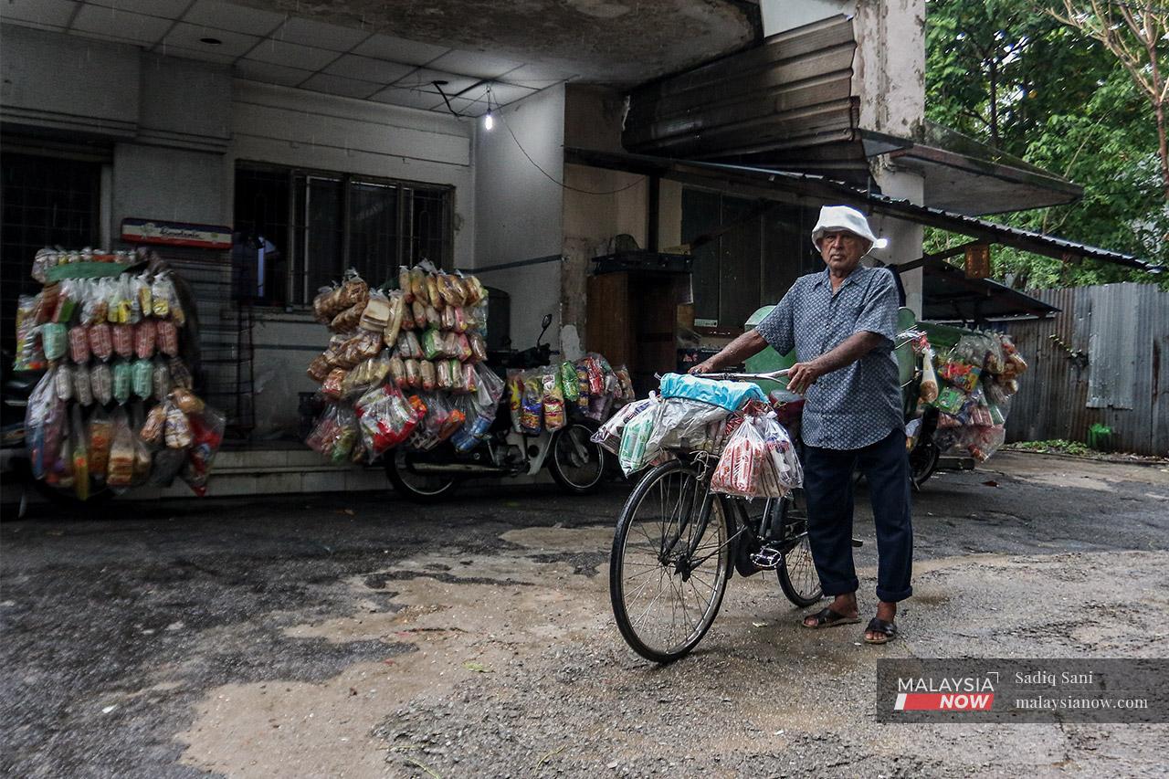 Abdul Hafiz Md Daud stands with his bicycle outside his home in Sentul, Kuala Lumpur. Now 73, he came to Malaysia from New Delhi in India at the age of 12, together with his father.
