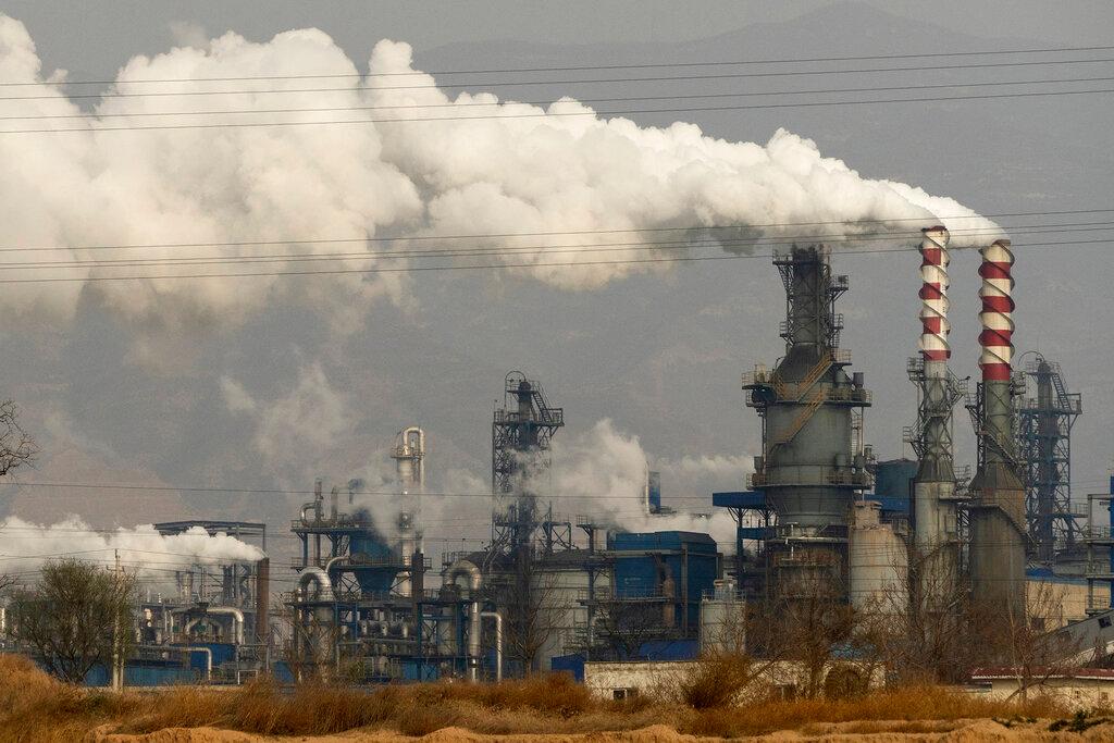 In this Nov 28, 2019, file photo, smoke and steam rise from a coal processing plant in Hejin in central China's Shanxi Province. A widening power crunch has forced production curbs across China in industries such as cement, steel and aluminium as power producers, unable to pay for coal, cut output. Photo: AP