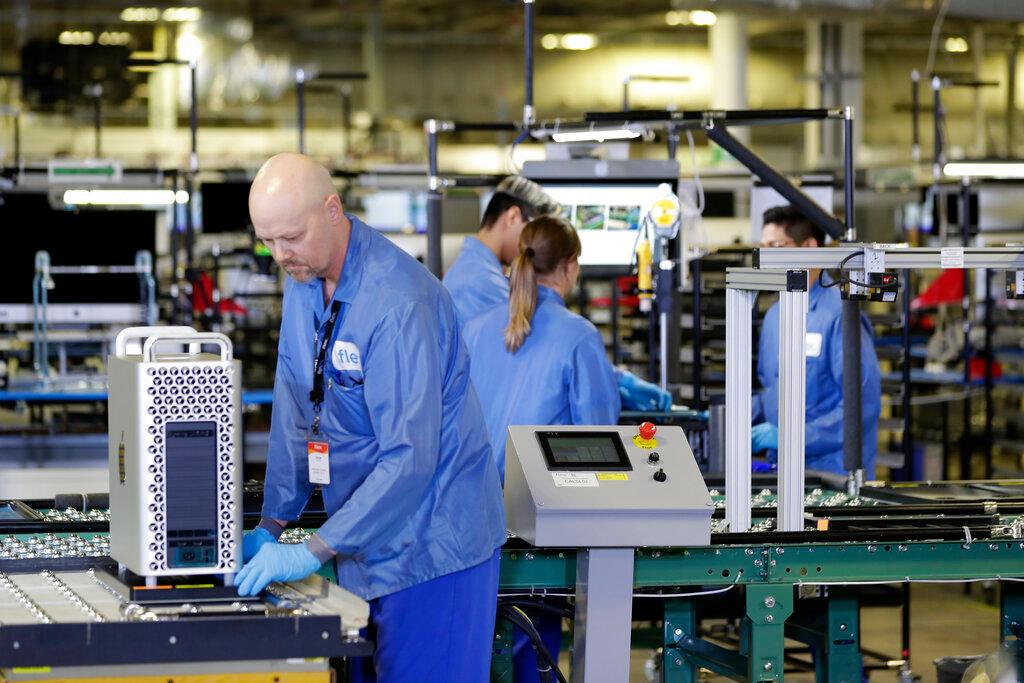In this Nov 20, 2019, file photo, workers assemble Apple products at an Apple manufacturing plant in Austin, Texas. In July, Apple forecast slowing revenue growth and said a chip shortage, which had started hitting its ability to sell Macs and iPads, would also crimp iPhone production. Photo: AP