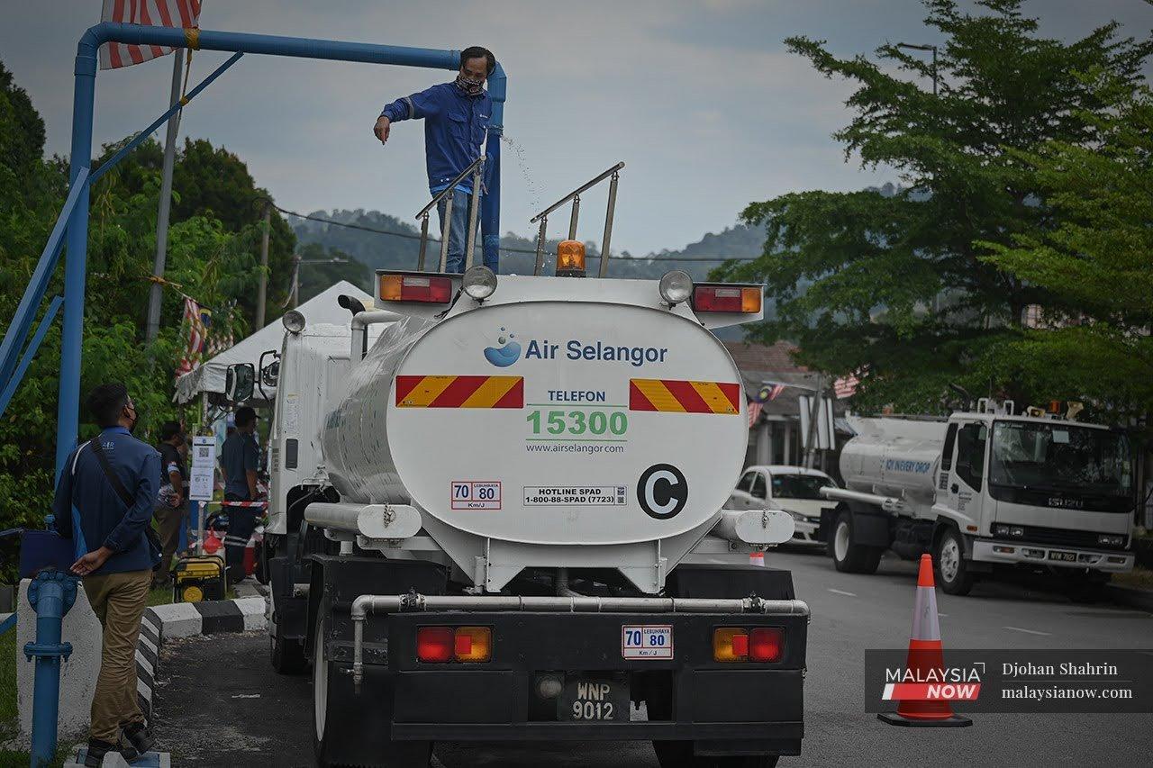 An Air Selangor worker fills a tanker with water to be distributed around Lembah Jaya, Ampang, yesterday.