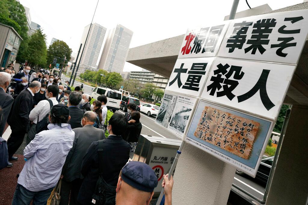 Plaintiffs and their supporters gather to walk toward the Tokyo District Court, Oct 14. The court is hearing five ethnic Korean residents of Japan and a Japanese national demanding the North Korean government pay compensation over their human rights abuses in that country after joining a resettlement programme there that promised a 'paradise on Earth'. Photo: AP