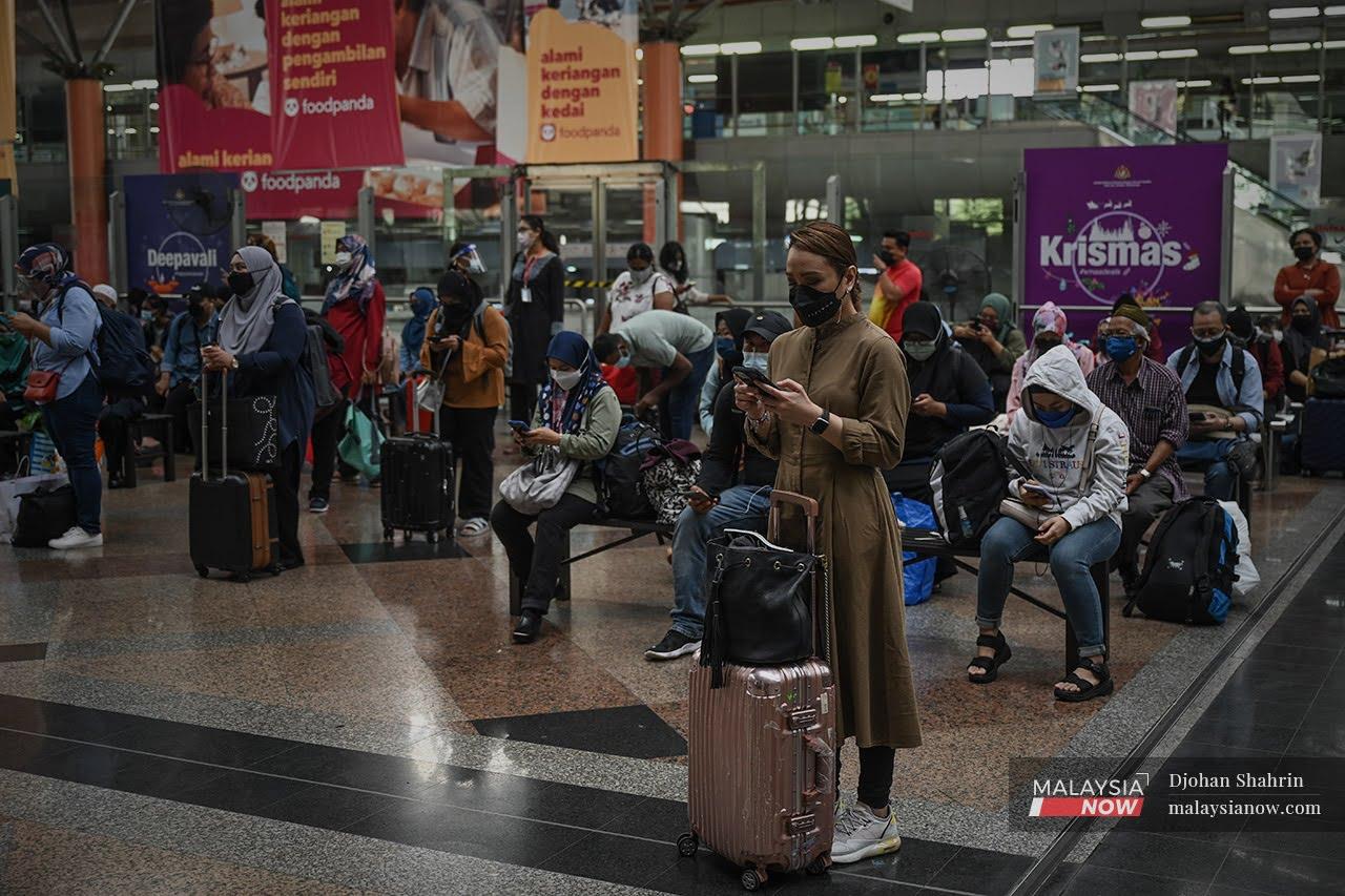 Travellers wait for their train to arrive at the KL Sentral KTM station after the government's green light for those who have been fully vaccinated to cross state lines.