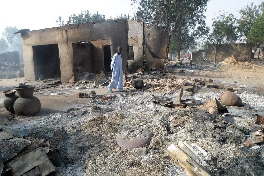 In this Jan. 31, 2016 file photo, a man walks past burnt out houses following an attack by Boko Haram in Dalori village near Maiduguri, Nigeria. Abu Musab al-Barnawi, the leader of the insurgent group Islamic State West Africa Province – an offshoot of Boko Haram – is said to be dead. Photo: AP