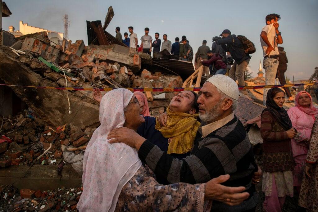 Villagers wail as they stand near the debris of a house destroyed in a gunfight in Pampore, south of Srinagar, Indian controlled Kashmir, Oct 16. Photo: AP