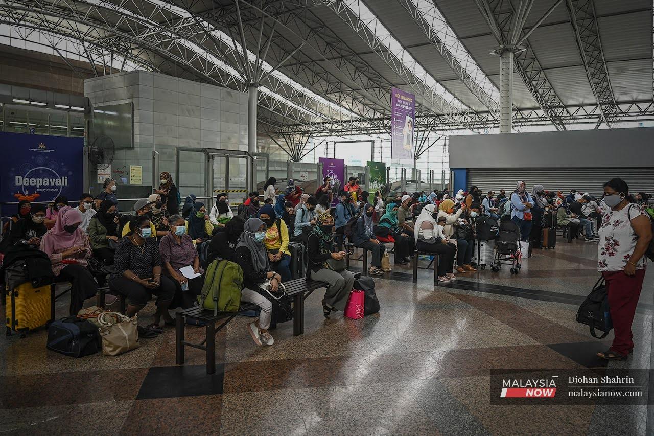 Travellers wait for a train at the KL Sentral station, as restrictions on interstate travel are eased for the fully vaccinated.