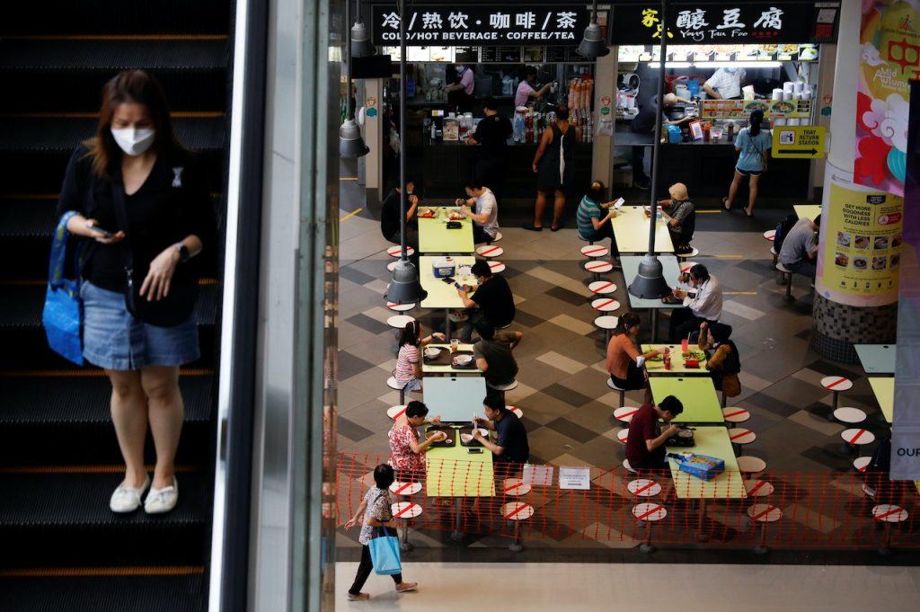 People dine in groups of two at a mall as restrictions on social gatherings are tightened due to the surge of Covid-19 cases, in Singapore, Sept 29. Photo: Reuters