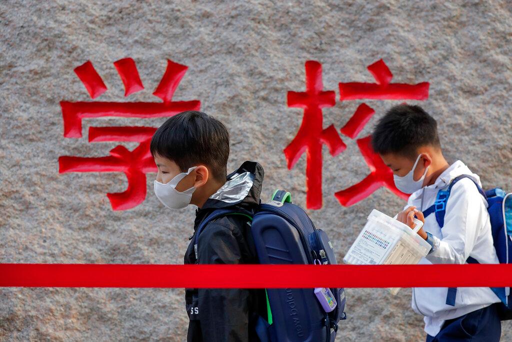 In this Sept 7, 2020 file photo, students wearing face masks to help curb the spread of the coronavirus walk in line as they arrive at a primary school in Beijing. Photo: AP