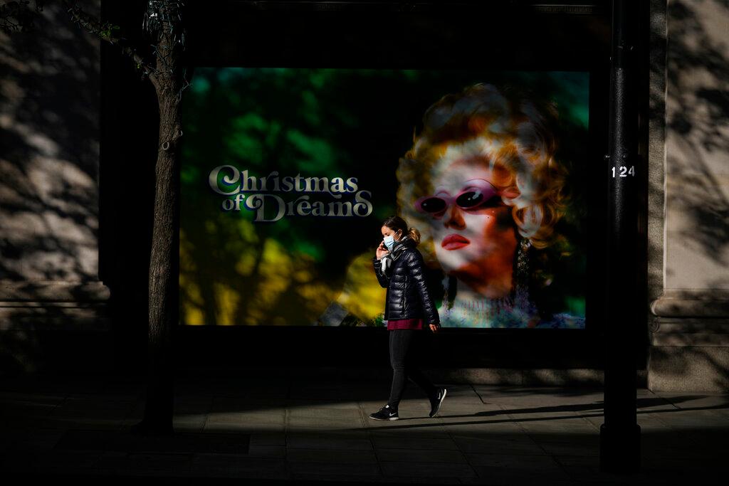 A woman wearing a face mask to curb the spread of coronavirus walks along the Oxford Street shopping area of central London, Oct 20. Photo: AP