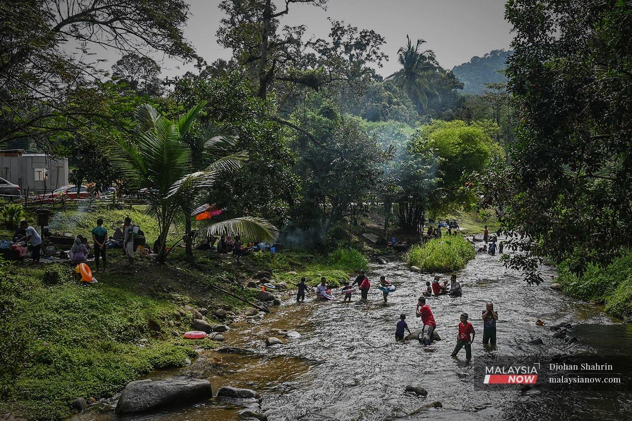Families splash about in the water at Sungai Congkak, Hulu Langat in Selangor as more restrictions are gradually lifted for the fully vaccinated.