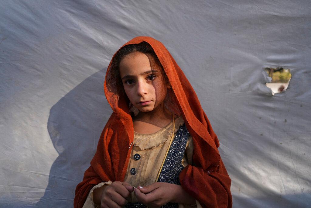 An Afghan girl from Kunduz province poses for a photo at a camp for internally displaced people as she waits for a bus to return home, in Kabul, Afghanistan, Oct 9. Village and displaced people's camp leaders say the numbers of young girls getting betrothed started to rise during a 2018 famine and surged this year when the rains failed once more. Photo: AP