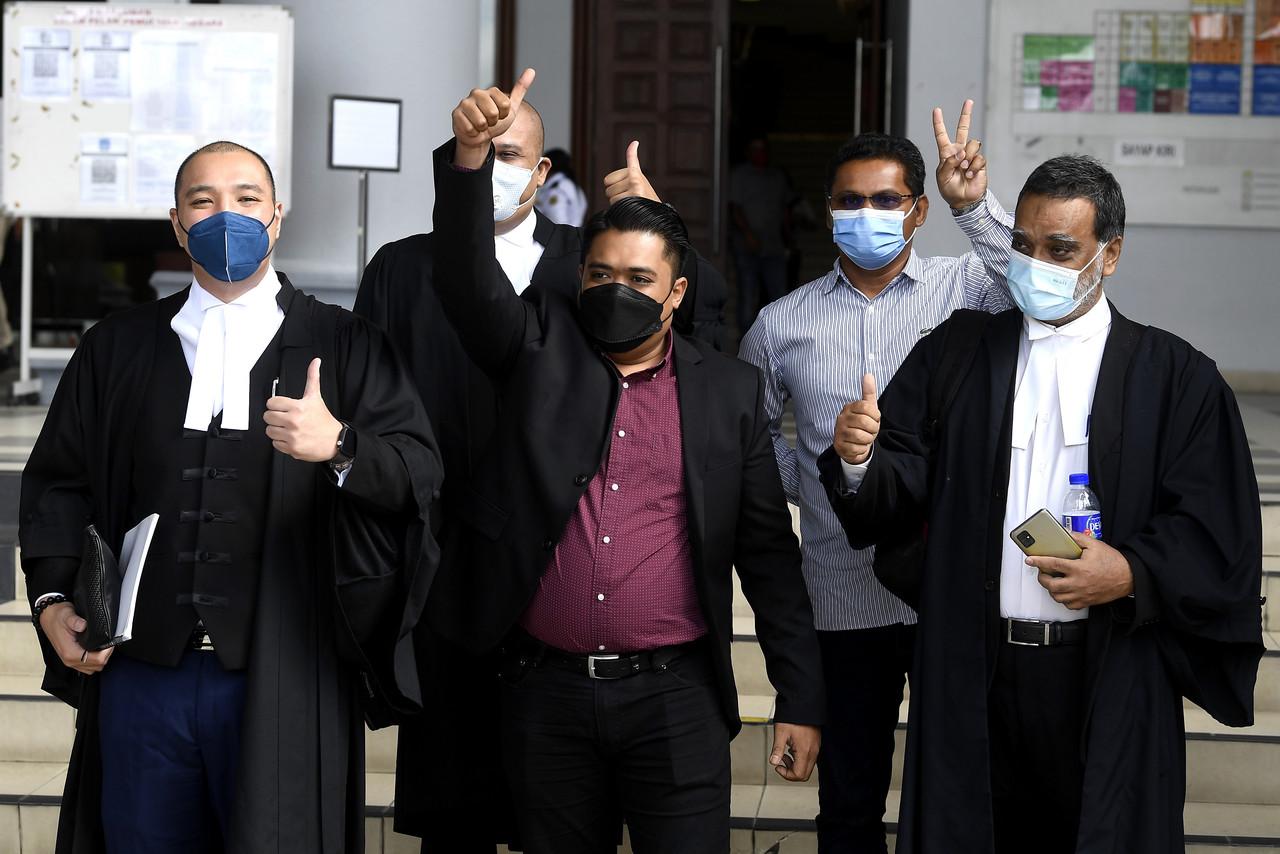 Ahmad Saiful Islam (centre), the son of former defence minister Mohamad Sabu, gestures outside the Kuala Lumpur court complex after being freed of the drug abuse charge made against him two years ago. Photo: Bernama