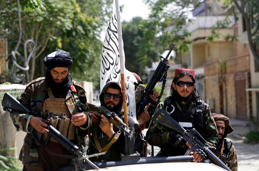 In this Aug 19 file photo, Taliban fighters display their flag on patrol in Kabul, Afghanistan. Photo: AP