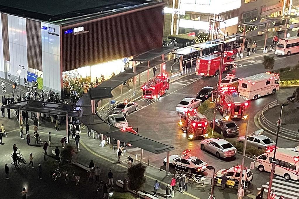 This aerial image shows firefighters and rescue workers gathered outside Kokuryo Station on the Keio Line in the city of Chofu in western Tokyo on Oct 31, after a man injured at least 17 people in a knife and fire attack on a train. Photo: AFP