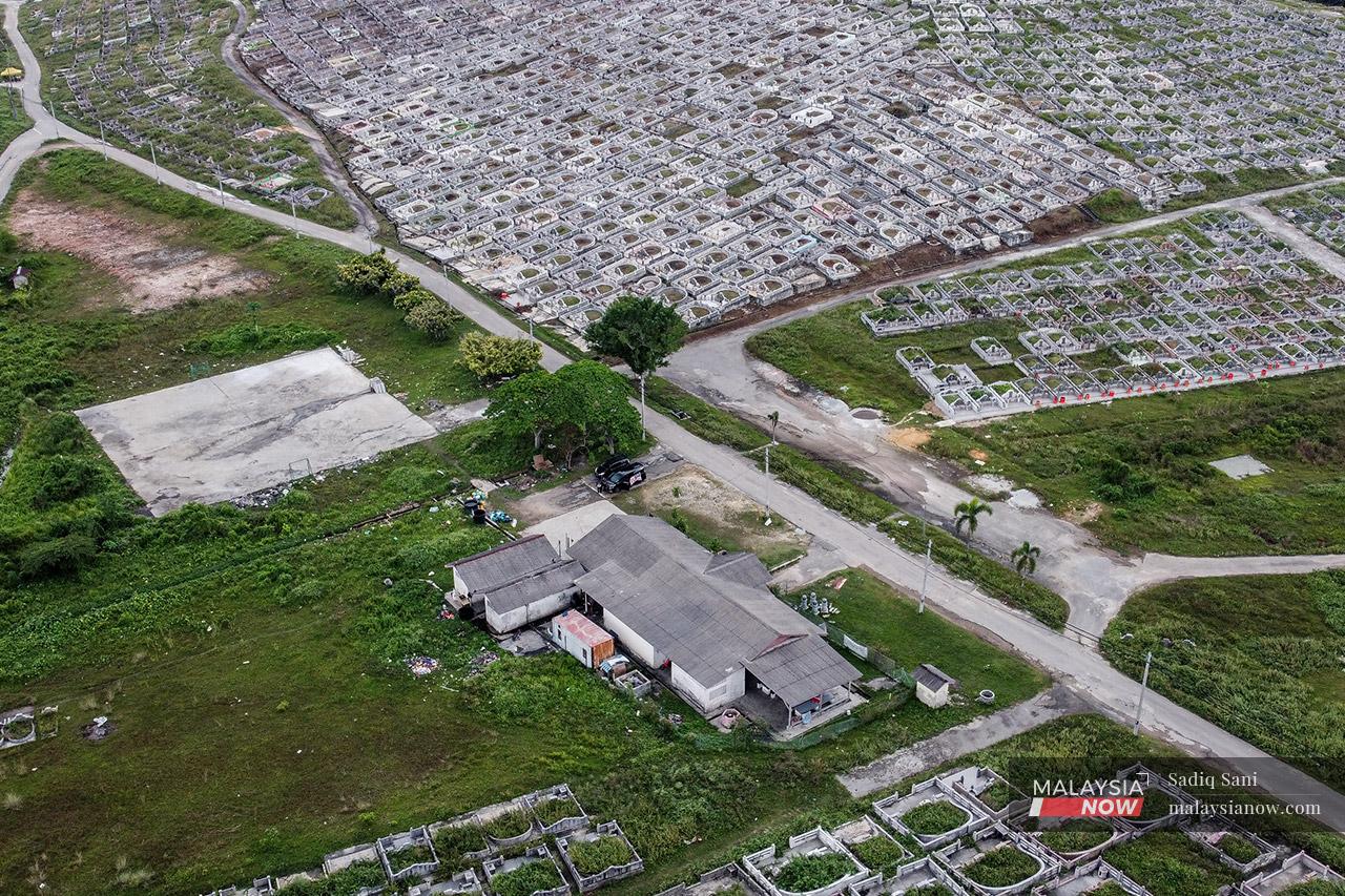 An aerial view of the abandoned temple, surrounded by gravestones, at the Meru Christian Cemetery in Klang where Mogana and her family live.