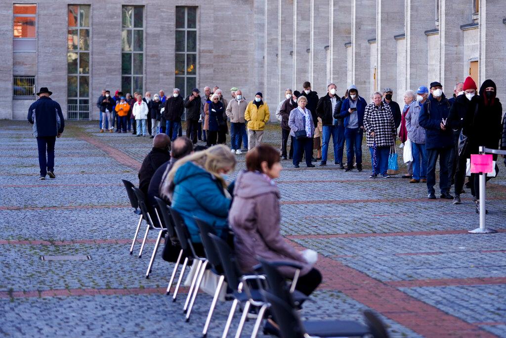 People line up for vaccination jabs in front of at the vaccination centre of the Malteser relief service on the fair grounds in Berlin, Germany, Nov 3. Photo: AP
