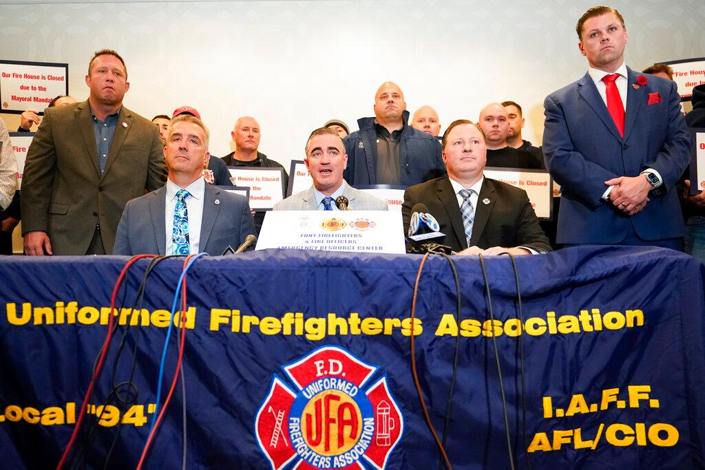 Representatives from fire fighters associations in New York speak at a press conference to protest the city's Covid-19 vaccine mandate on Nov 2.  The mayor's Oct 20 order, which police and firefighter union leaders says would cause staff shortages, led to an 11th-hour rush of inoculations that shrank the ranks of the unvaccinated as officials in the largest US city began enforcing the mandate. Photo: AP
