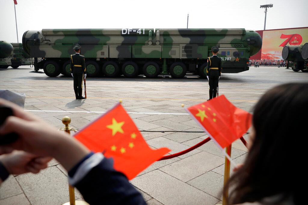 Spectators wave Chinese flags as military vehicles carrying DF-41 ballistic missiles roll during a parade to commemorate the 70th anniversary of the founding of Communist China in Beijing, Oct 1, 2019. China is expanding its nuclear force much faster than US officials predicted just a year ago, according to a Pentagon report released Nov 3. Photo: AP