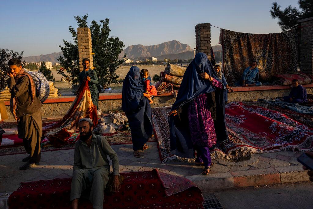 Afghan women walk through a second-hand market where many families sold their belongings before leaving the country or due to financial struggle, in Kabul, Afghanistan, Sept 15. Photo: AP