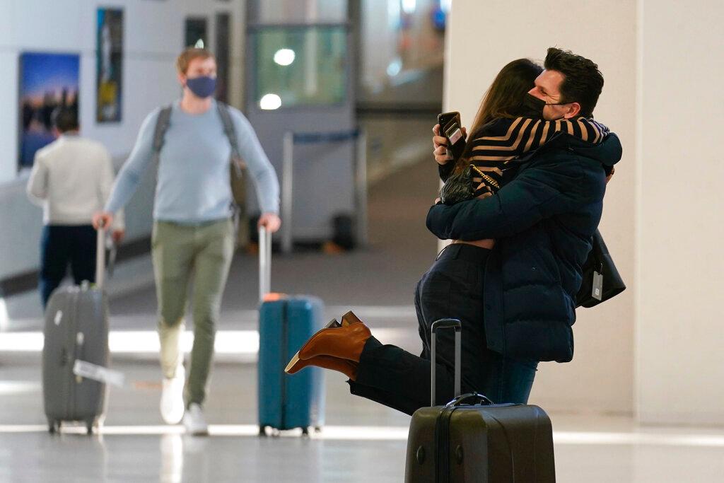 A couple embrace as they greet each other at Newark Liberty International Airport in Newark, New Jersey, Nov 8. The US lifted restrictions Monday on travel from a long list of countries including Mexico, Canada and most of Europe, setting the stage for emotional reunions nearly two years in the making. Photo: AP