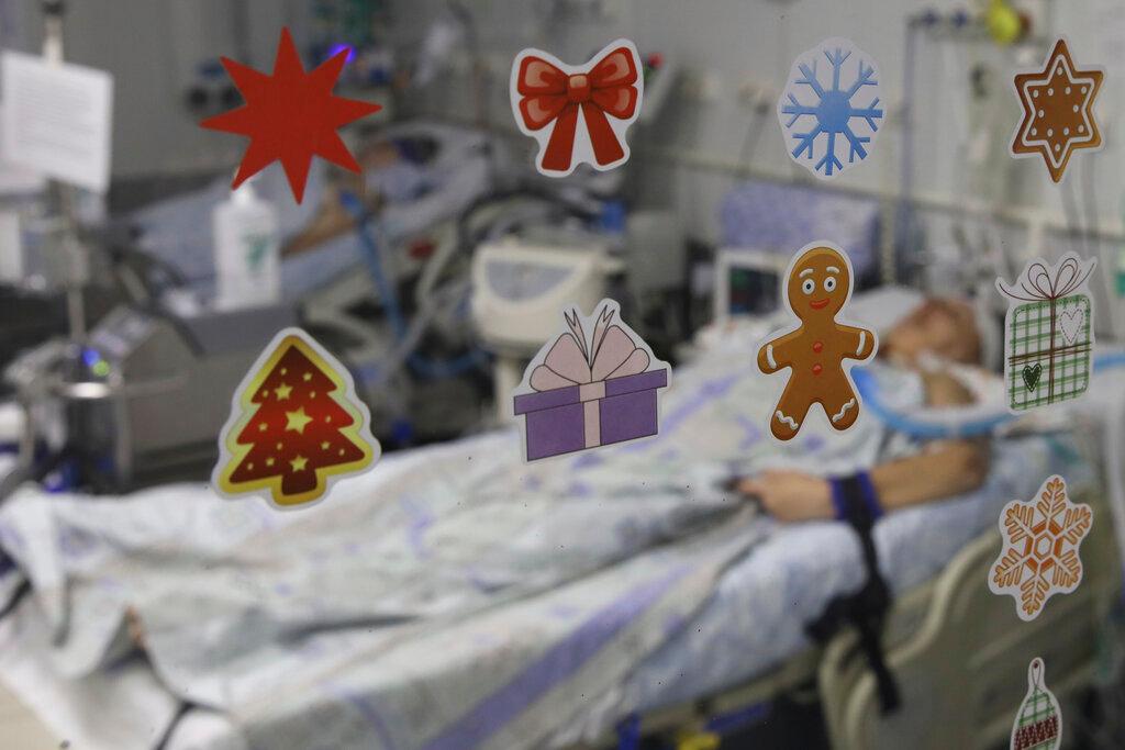 A patient with Covid-19 is seen through a door glass with stickers at an ICU at the Regional Clinical Hospital 1, in Krasnodar, south Russia, Nov 2. Photo: AP