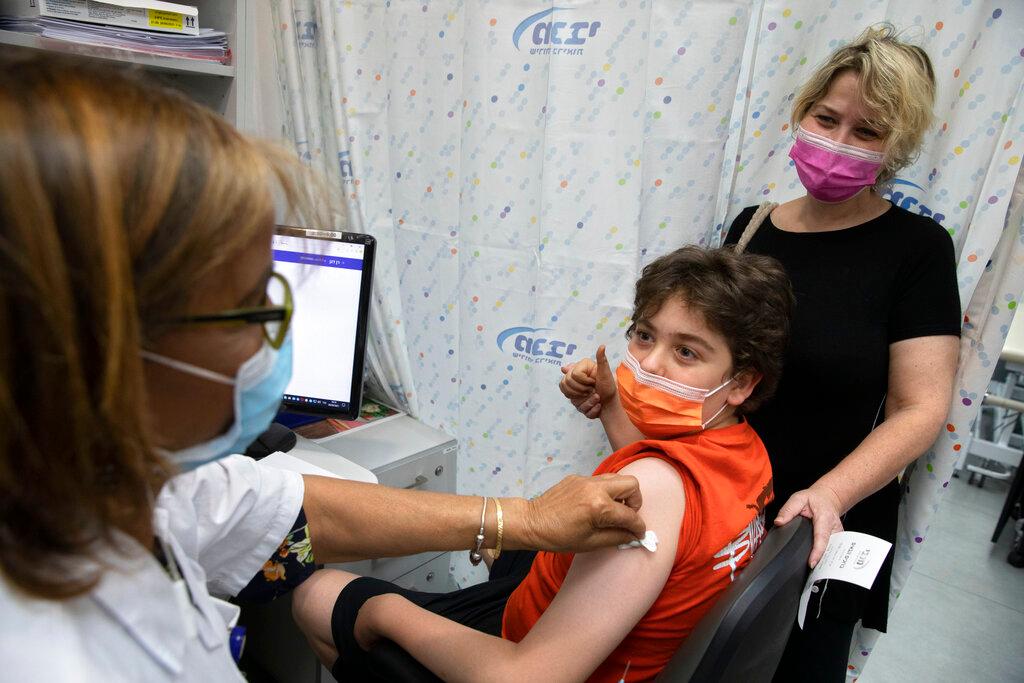 An Israeli youth receives a Pfizer-BioNTech Covid-19 vaccine in the central Israeli city of Rishon LeZion, June 6, when the country started vaccinating children from 12 to 15. Photo: AP
