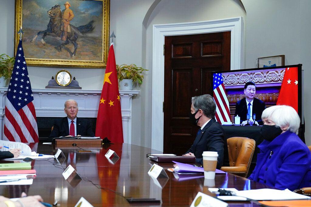 US President Joe Biden (left) speaks as he meets virtually with Chinese President Xi Jinping (on screen) from the Roosevelt Room of the White House in Washington, Nov 15. Photo: AP