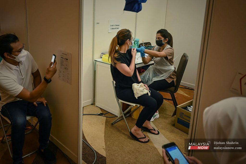 A health worker administers a second shot of Sinovac vaccine at the Movenpick vaccination centre in Sepang, Selangor, in this file photo.