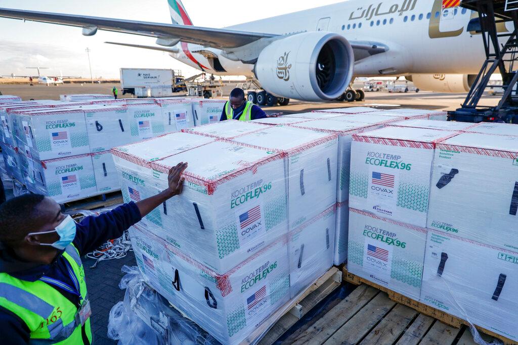 An airport worker stands next to boxes of Moderna coronavirus vaccine after their arrival at the airport in Nairobi, Kenya, Aug 23. Photo: AP