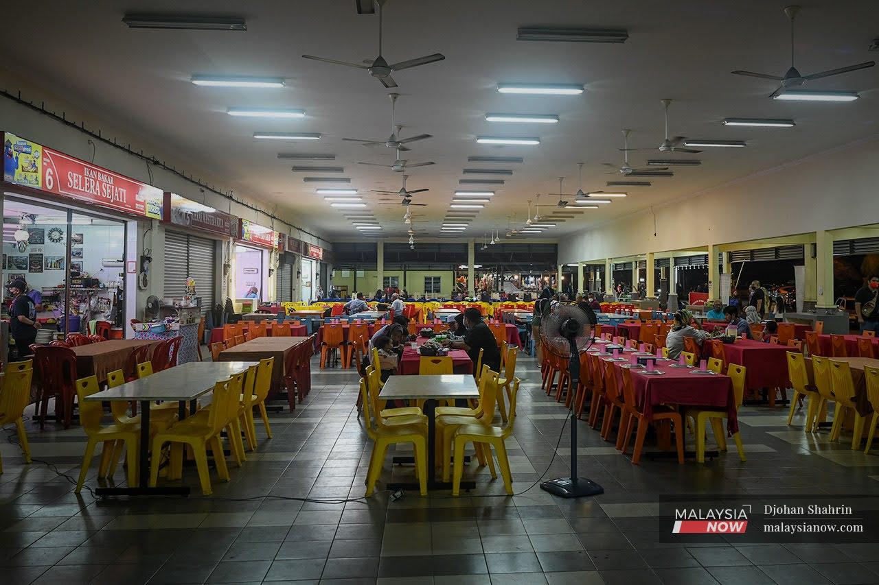 Customers enjoy a meal at a food court in Umbai, Melaka, which specalises in seafood.