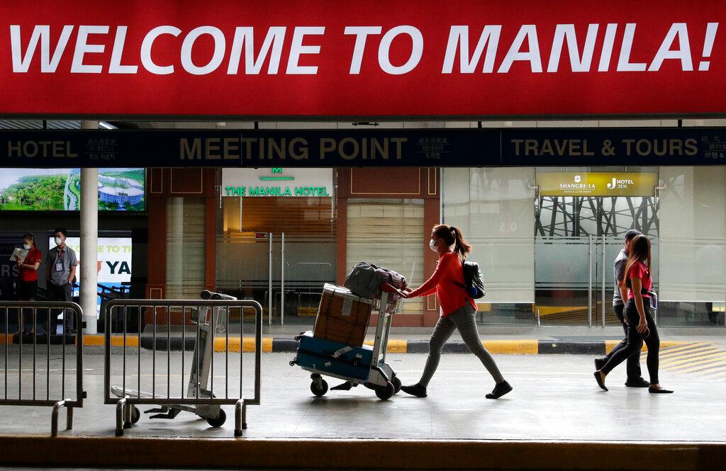 In this Feb 3, 2020, file photo, a woman wearing a protective face mask arrives at Manila's international airport in the Philippines. Photo: AP