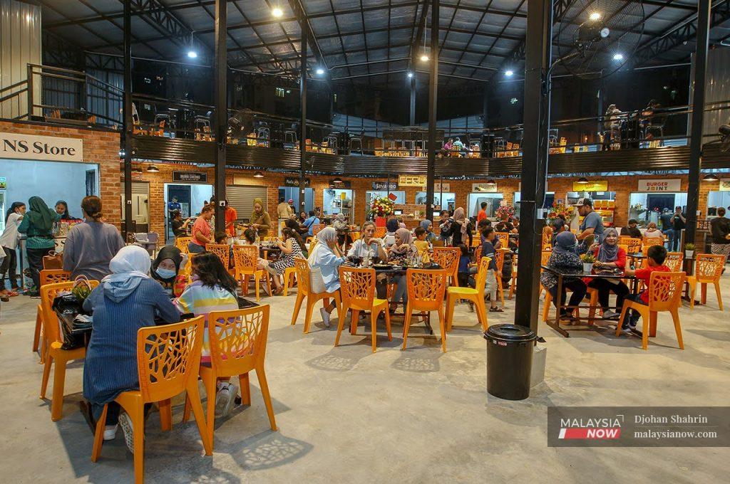 Customers enjoy a dine-in meal at a food court in Kuala Lumpur.