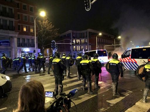 Riot police officers stand in position in a street of The Hague during a demonstration against the Dutch government's Covid-19 measures, on Nov 20. Photo: AFP