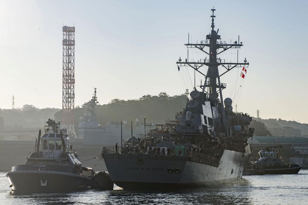 This handout photo released by the US Navy shows the Arleigh Burke-class guided missile destroyer USS John S McCain being pulled towards a pier after departing from a dry dock at Fleet Activities Yokosuka, Japan, Nov 27, 2018. The US Navy says the Arleigh Burke-class guided-missile destroyer Milius conducted a 'routine Taiwan Strait transit' through international waters in accordance with international law. Photo: AFP
