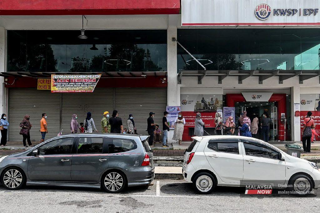 People line up in front of an EPF branch in Bandar Baru Nilai, Negeri Sembilan, following the government's announcement that contributors would be allowed to withdraw funds from their Account 1. Allowing EPF withdrawals was one of the government's initiatives to cushion the impact of Covid-19 on the people.