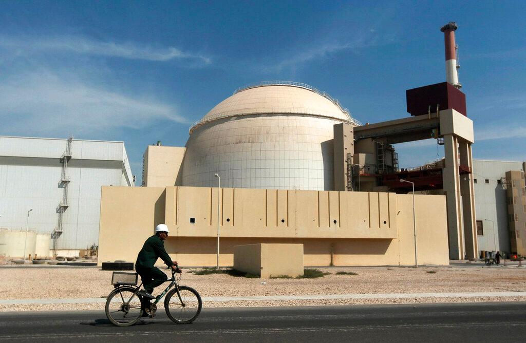A worker rides a bicycle in front of the reactor building of the Bushehr nuclear power plant, just outside the southern city of Bushehr, Iran, Oct 26, 2010. Photo: AP