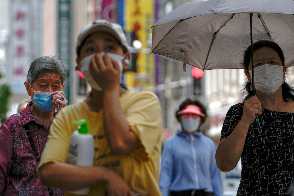 Women wearing face masks to help protect from the coronavirus walk through a popular shopping street in Shanghai, China, in this Aug 29 file photo. Photo: AP
