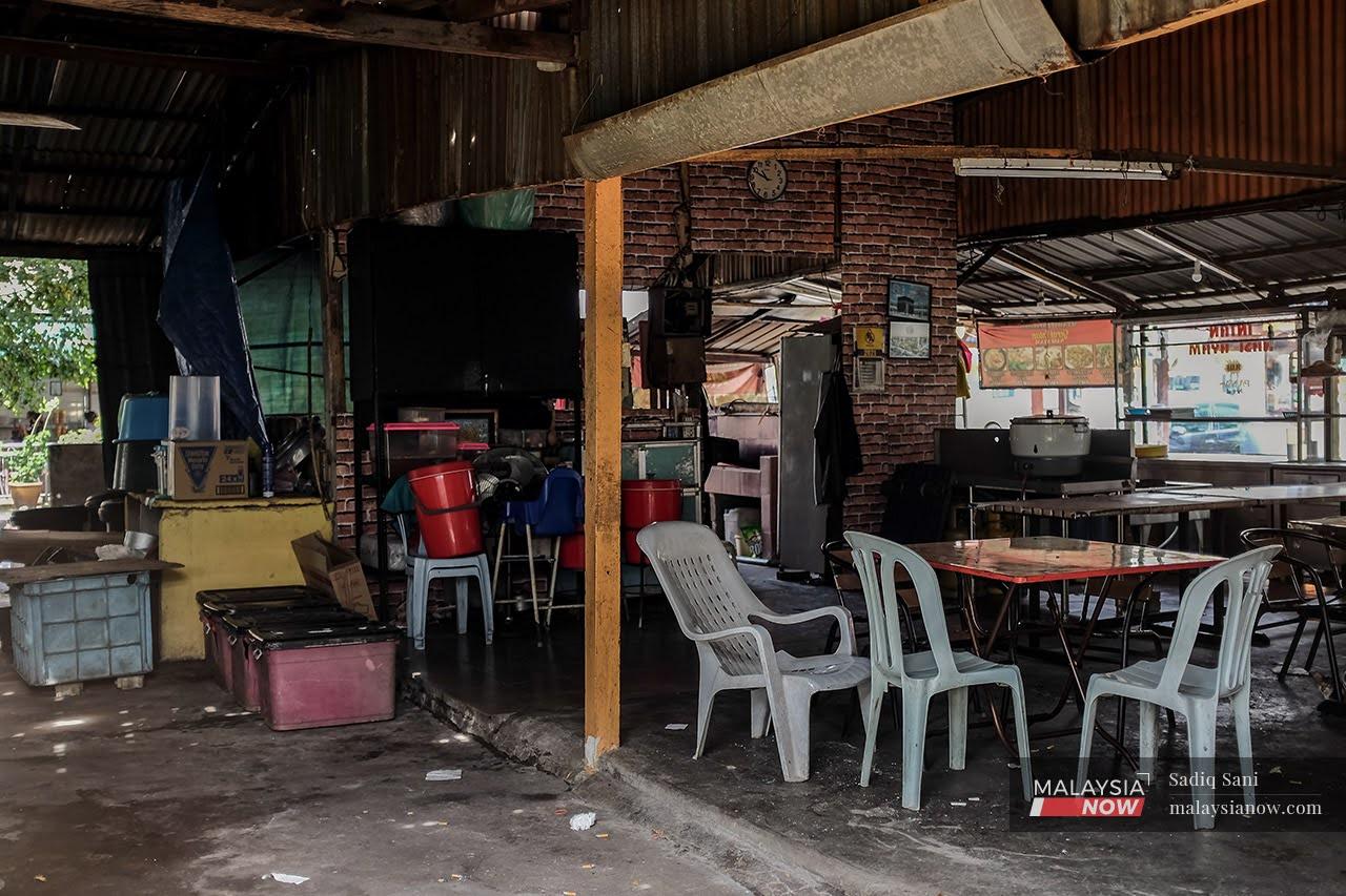 Rubbish lies on the floor of a food stall in SS19, Subang, with kitchen items piled haphazardly at the back.